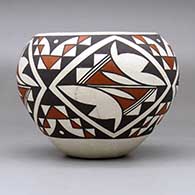 A polychrome jar decorated with a four-panel geometric design, click or tap to see a larger version
