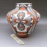 A large polychrome jar decorated with a four-panel butterfly, fine line and geometric design, Second Place ribbon from Santa Fe Indian Market 1993
 by Evelyn Cheromiah of Laguna