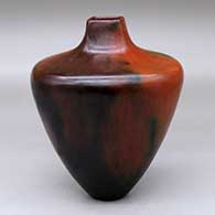 A brown vase with a squarish opening and decorated with fire clouds
 by Alice Cling of Dineh