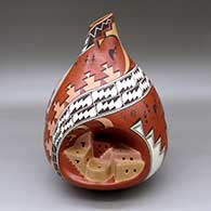 A polychrome jar with an organic opening and decorated with a sculpted pueblo inset plus kokopellis, medallions and geometric designs
 by Cecilia McKelvey of Dineh