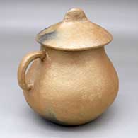 A lidded golden micaceous pitcher with a handle and fire clouds
 by Cecilia A Martinez of Picuris