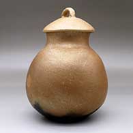 A lidded golden micaceous jar with fire clouds, click or tap to see a larger version