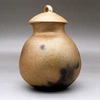 A lidded golden micaceous jar with fire clouds, click or tap to see a larger version