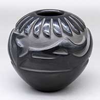 A black jar carved with an avanyu, band-of-feathers and geometric design
 by Yolanda Velarde of Santa Clara