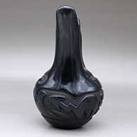 A black wedding vase carved around the body with an avanyu and geometric design, click or tap to see a larger version