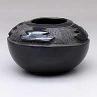 A black jar carved with a four-panel geometric design above the shoulder
 by Myra Little Snow of Santa Clara