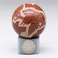 A miniature red seed pot decorated with a sgraffito flying geese and geometric design, click or tap to see a larger version