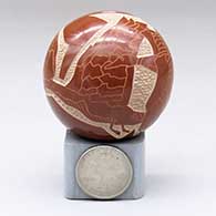 A miniature red seed pot decorated with a sgraffito flying geese and geometric design, click or tap to see a larger version