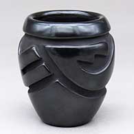 A black jar carved with an avanyu design around the body
 by Gracie Naranjo of Santa Clara