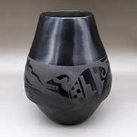 A large black-on-black jar decorated with an avanyu and geometric design
 by Carmelita Dunlap of San Ildefonso