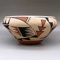 A large, open polychrome bowl decorated with a bird element and geometric design around the body, click or tap to see a larger version