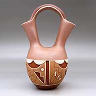 A polychrome Potsuwii-style wedding vase carved and painted around the body with a four-panel feather, kiva step and geometric design, plus micaceous clay above and below the carved band, click or tap to see a larger version