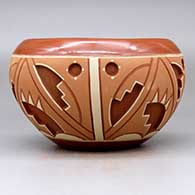 A polychrome Potsuwii-style jar decorated with a four-panel painted and carved kiva step and geometric design around the body, click or tap to see a larger version