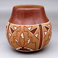 A polychrome Potsuwii-style jar decorated with a four-panel painted and carved feather, kiva step and geometric design around the body
 by Rosita de Herrera of Ohkay Owingeh