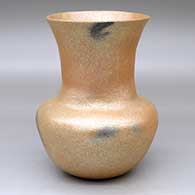 A golden micaceous vase decorated with fire clouds
 by Angie Yazzie of Taos