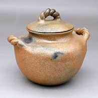 A lidded golden micaceous bean pot with twisted handles and fire clouds
 by Angie Yazzie of Taos