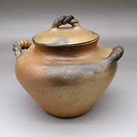 A lidded golden micaceous bean pot with twisted handles and fire clouds
 by Angie Yazzie of Taos