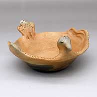 A golden micaceous bird bowl with a notched rim, carved tail and fire clouds
 by Teri Lujan Lucero of Taos