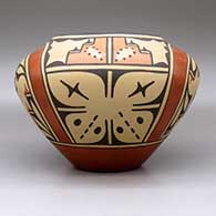 A polychrome jar decorated with a four-panel roadrunner, butterfly, rainbow,cloud formation and geometric design, click or tap to see a larger version