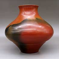 A brown jar with a recurved rim and fire clouds, click or tap to see a larger version