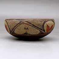 A polychrome chili bowl polished inside and decorated with a six panel leaf, fineline and geometric design, click or tap to see a larger version