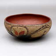 A polychrome chili bowl polished inside and decorated with a six panel leaf, fineline and geometric design
 by Unknown of Zia