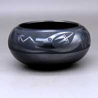 A gunmetal black on black bowl decorated with an avanyu and geometric design above the shoulder
 by Maria Martinez of San Ildefonso