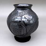 Black-on-black jar with a flared opening, convex details on body, and a geometric design
 by Eduardo Ortiz aka Chevo of Mata Ortiz and Casas Grandes