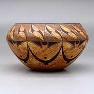 A black on mixed clay bowl decorated with bands of geometric design above and below the shoulder, click or tap to see a larger version