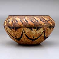 A black on mixed clay bowl decorated with bands of geometric design above and below the shoulder, click or tap to see a larger version