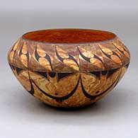 A black on mixed clay bowl decorated with bands of geometric design above and below the shoulder
 by Calvin Analla Jr of Laguna