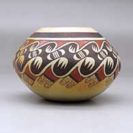 A polychrome jar decorated around the shoulder with a bat wing, bird element and geometric design, click or tap to see a larger version
