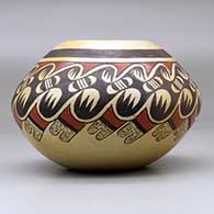 A polychrome jar decorated around the shoulder with a bat wing, bird element and geometric design, click or tap to see a larger version