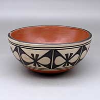 A polychrome chili bowl polished on the inside and decorated around the outside with a butterfly geometric design
 by Arthur Coriz of Santo Domingo