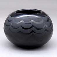 A black on black bowl decorated with a wavy geometric pattern
 by Santana Martinez of San Ildefonso