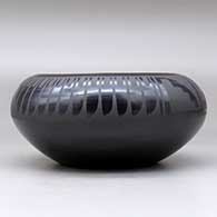 A black on black bowl decorated with a four-panel feather and geometric design above the shoulder, click or tap to see a larger version