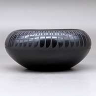 A black on black bowl decorated with a four-panel feather and geometric design above the shoulder, click or tap to see a larger version