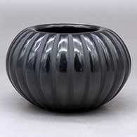 A black melon bowl carved with 24 ribs
 by Angela Baca of Santa Clara
