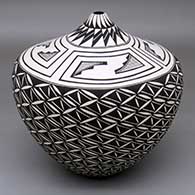 A black-on-white tear drop jar decorated with a spiraling North Star snowflake and geometric design
 by Cletus Victorino of Acoma