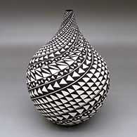 A black-on-white thin-neck jar decorated with a spiraling geometric design
 by Sandra Victorino of Acoma