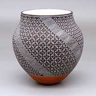 A polychrome jar with a four-panel fine line and geometric design
 by Rebecca Lucario of Acoma