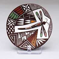 A small polychrome plate decorated with a dragonfly, fine line and geometric design
 by Carolyn Concho of Acoma