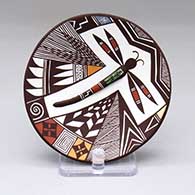 A small polychrome plate decorated with a dragonfly, spiral, fine line and geometric design
 by Carolyn Concho of Acoma