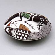 A polychrome seed pot decorated with a lizard applique and a fine line and geometric design
 by George Concho of Acoma