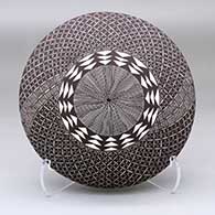 A black-on-white seed pot decorated with a North Star fine line and geometric design
 by Amanda Lucario of Acoma