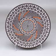 A polychrome plate decorated with a North Star fine line, pumpkin seed snowflake and geometric design
 by Rebecca Lucario of Acoma