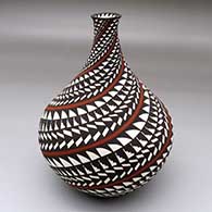 A polychrome thin neck jar decorated with a spiraling geometric design
 by Sandra Victorino of Acoma