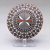 A polychrome seed pot decorated with a fine line, pumpkin seed snowflake and geometric design
 by Rebecca Lucario of Acoma