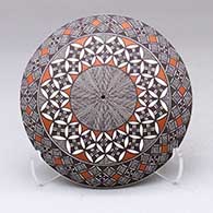 A polychrome seed pot decorated with a North Star fine line, pumpkin seed snowflake and geometric design
 by Rebecca Lucario of Acoma