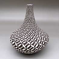 A tall-necked polychrome vase decorated with a spiraling Snowy Night geometric design
 by Sandra Victorino of Acoma